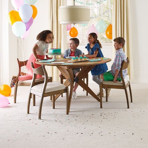 kids playing around a table on a beige carpet floor from Katy Carpets in Katy, TX