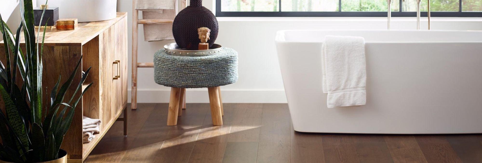 white bathtub with brown waterproof flooring from Katy Carpets in Katy, TX